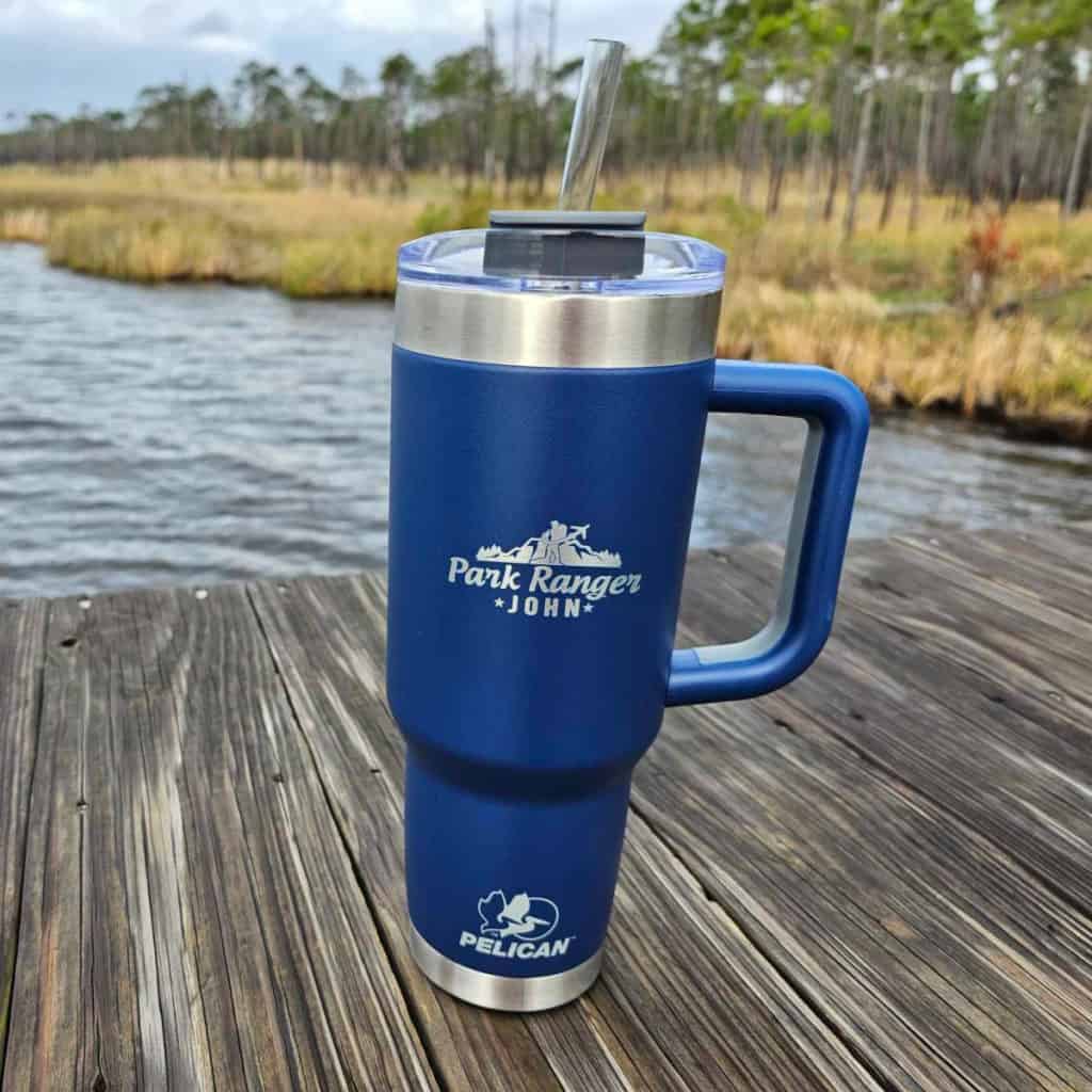 Photo of a Pelican Porter Tumbler sitting on a rail of a boardwalk in Gulf State Park Alabama