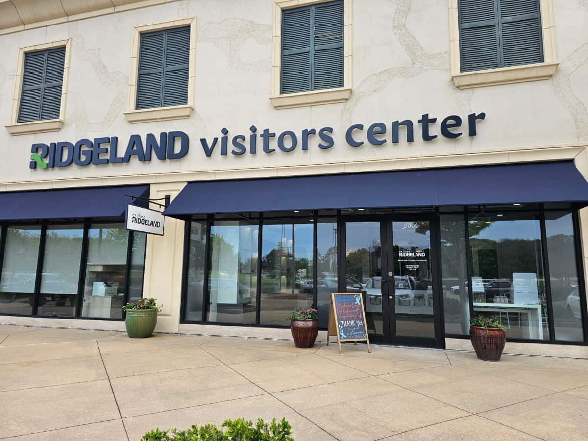 Ridgeland Visitor Center sign over a blue awning and glass entrance doors. 