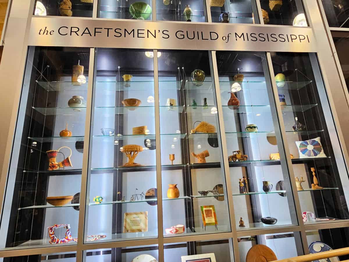 The craftsman guild of Mississippi sign over a glass gallery art display. 