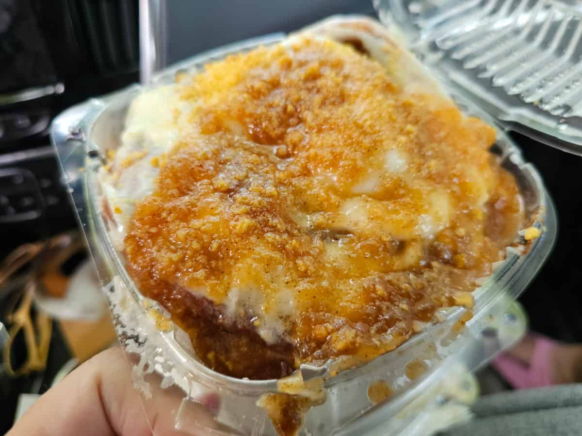 Apple Cobbler Cinnamon roll held in a plastic container