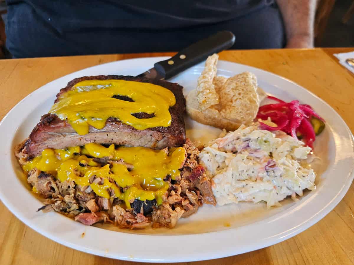 BBQ Rib plate with ribs, pork rind, mac salad, and pickled onions