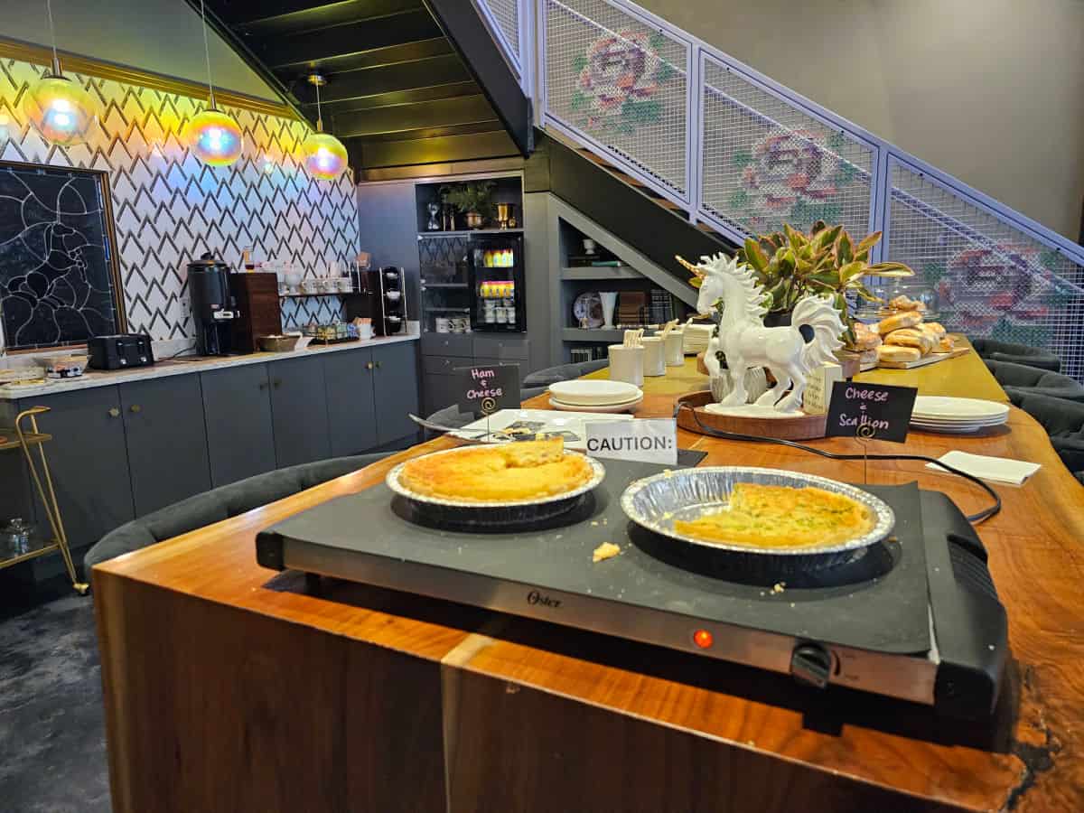 Breakfast on a long counter with a unicorn and coffee makers in the background