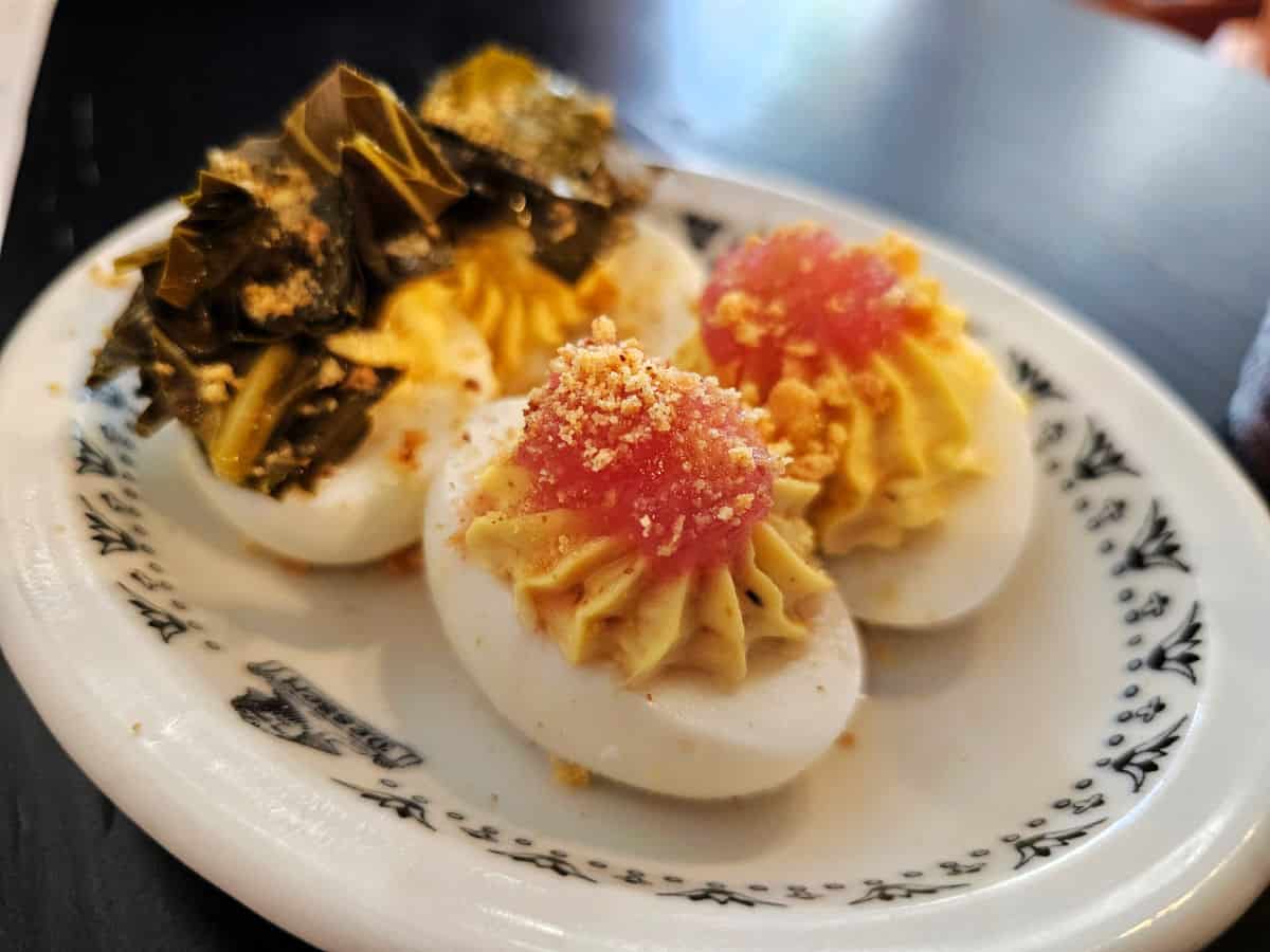 Four deviled eggs on a white plate