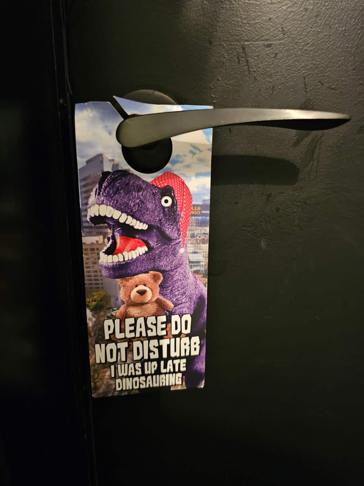 Dinosaur do not disturb sign hanging from a door handle