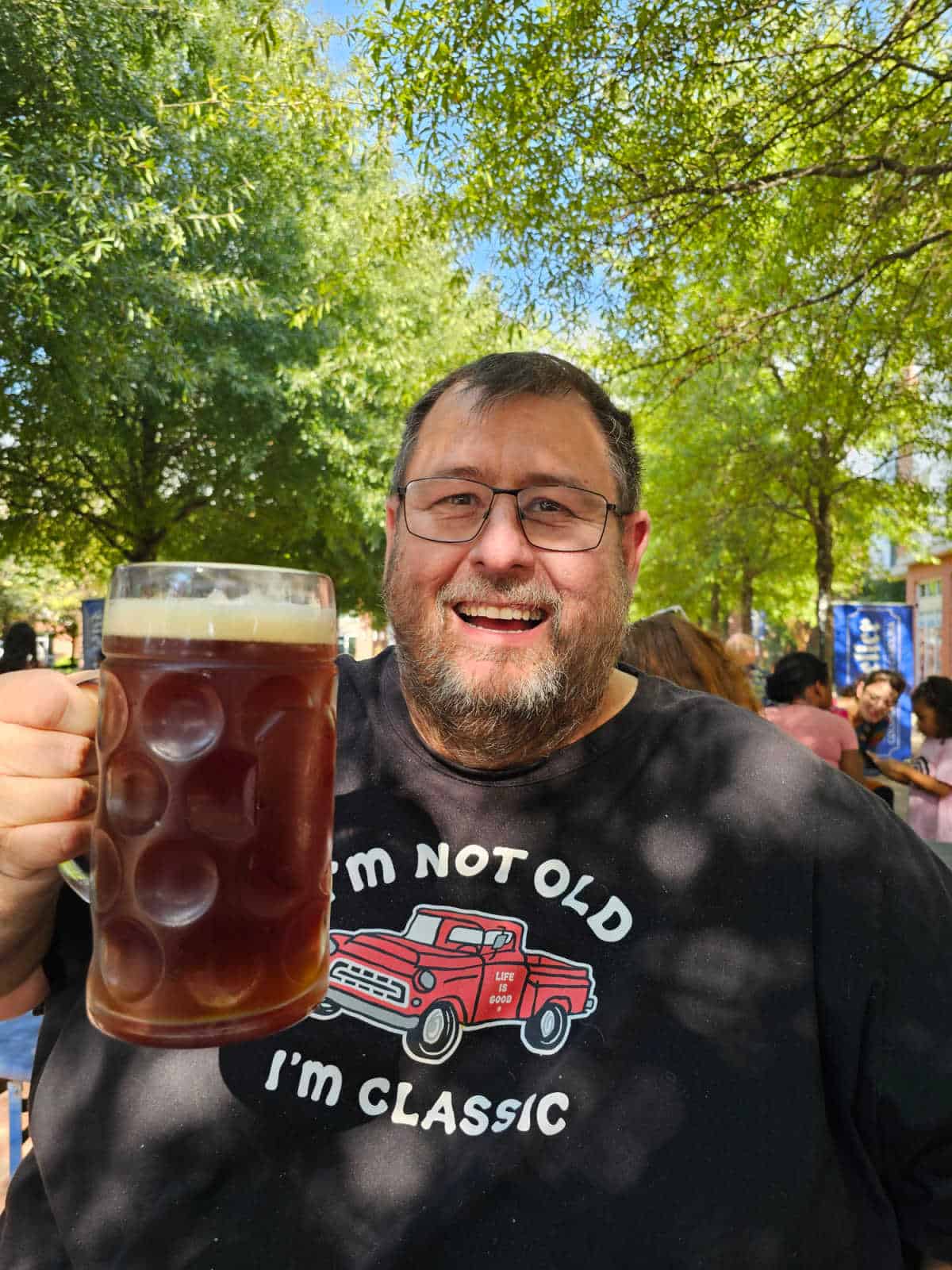 John holding a liter mug