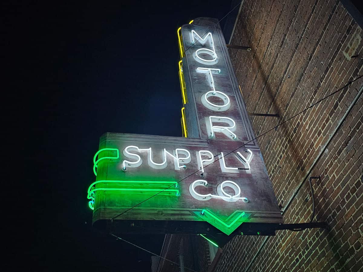 Motor Supply Co neon sign on a brick building