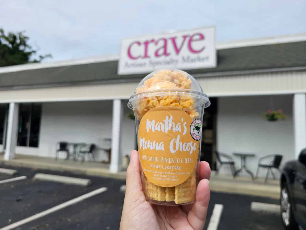 Martha's Pimento Cheese Cup in front of Crave Artisan Market Sign