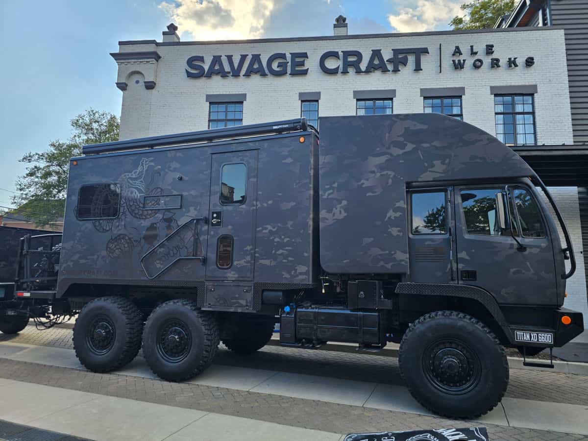 Large utility vehicle in front of Savage Craft Ale Works building 