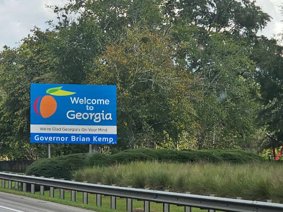 Welcome to Georgia highway sign by trees and guard rail