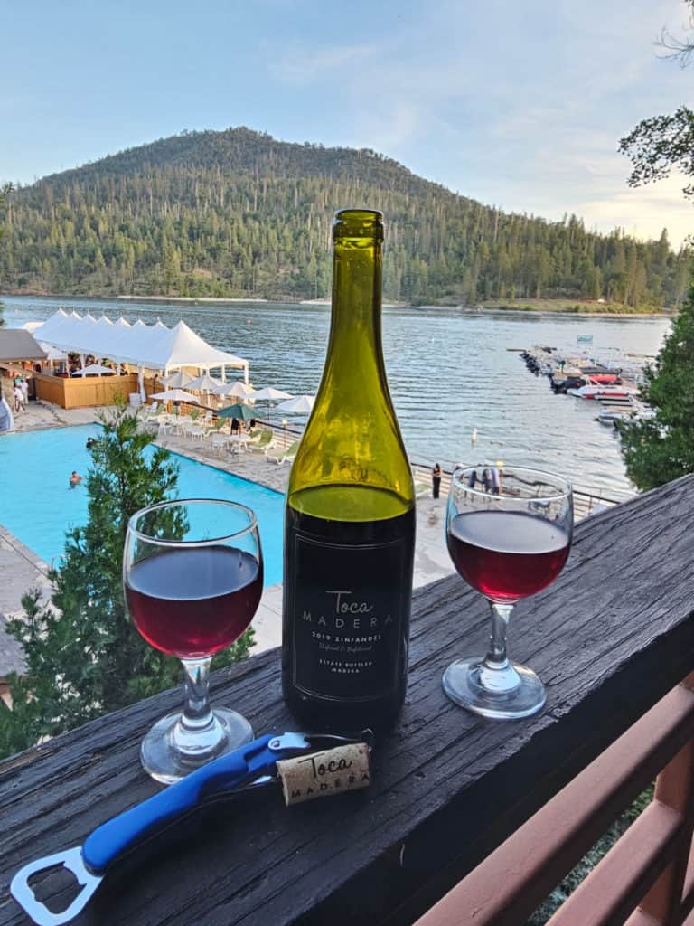 Glass of wine on the back deck of our Lakeside Suite at The Pines Resort in Bass Lake Calif