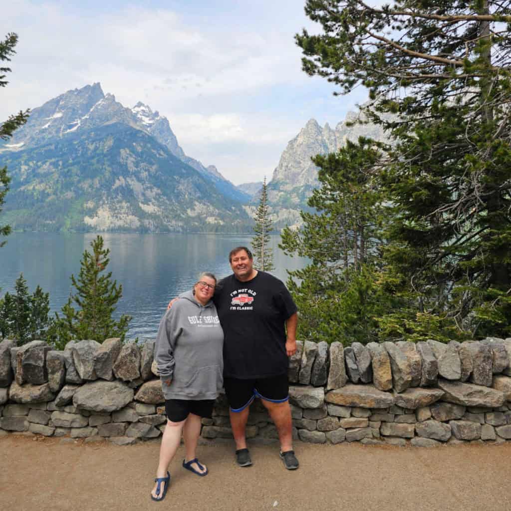 John and Tammilee standing in front of Jenny Lake in Grand Teton National Park, Wyoming