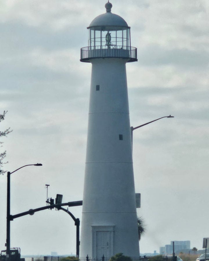 Biloxi Lighthouse with light poles near it